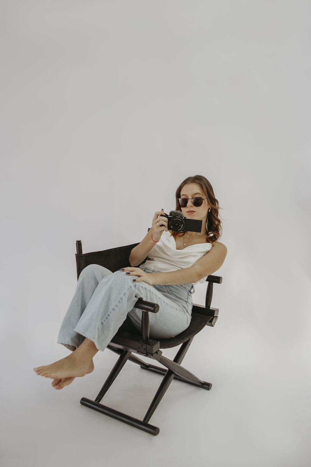 Julia sentada, relaxada, com câmera